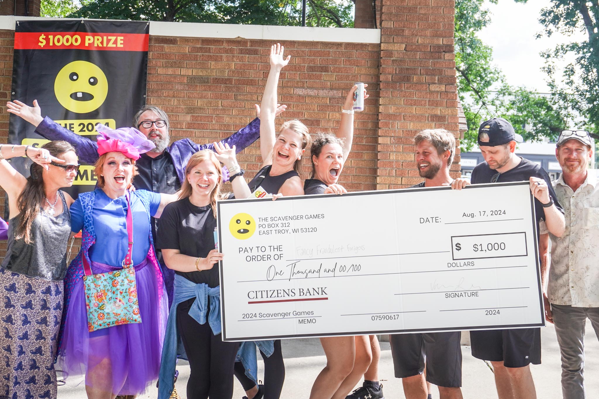 The winners of the scavenger games holding a large check